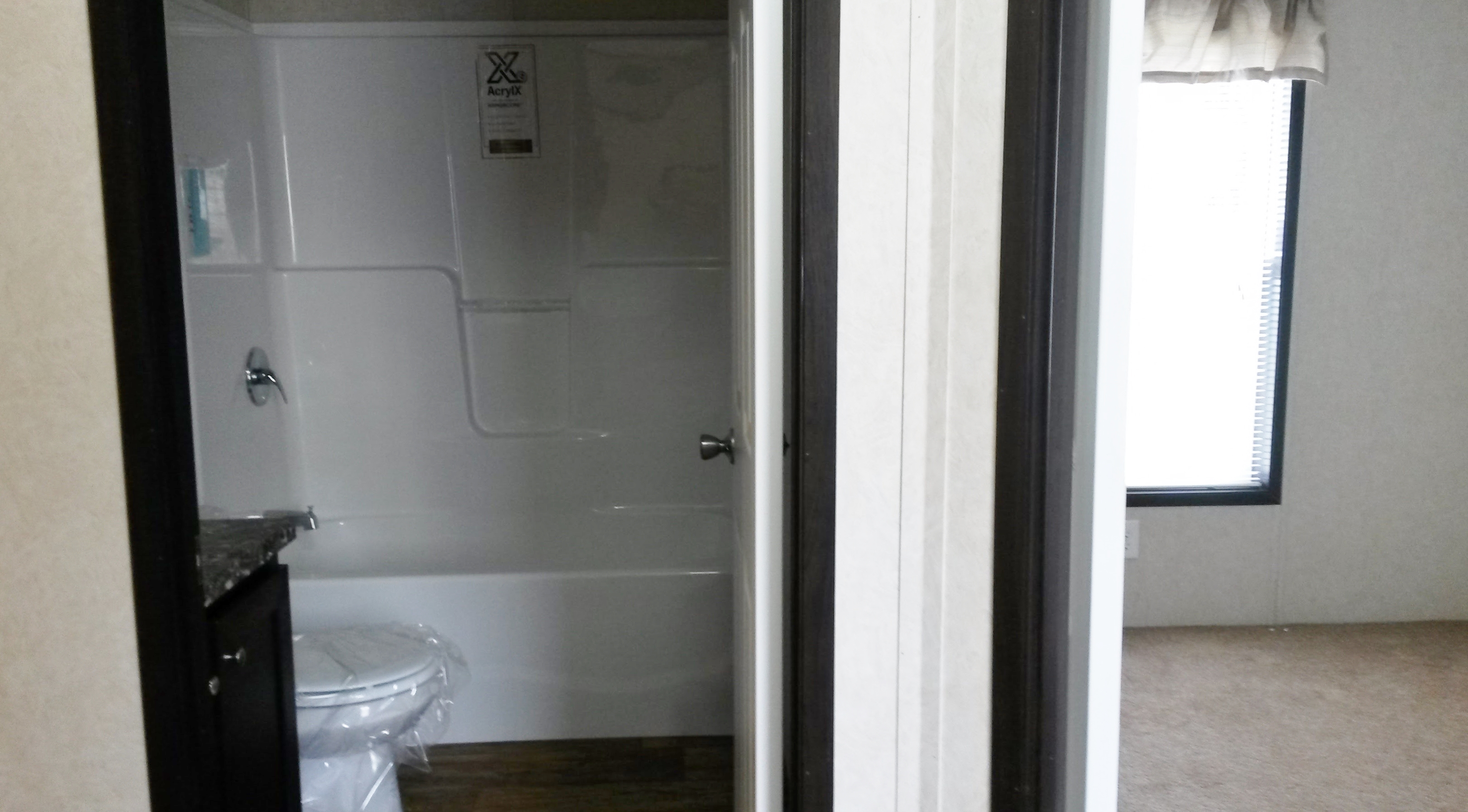 Shot of bedroom 2 and community bath off hall