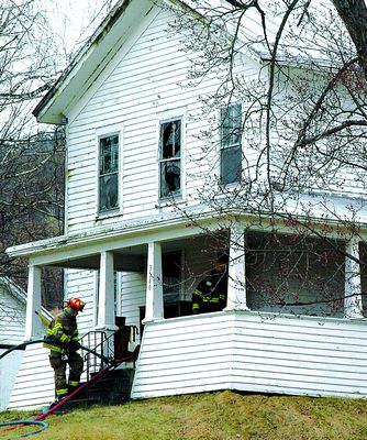 Firefighters take woman out of burning home