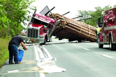 Log truck flips on Route 20