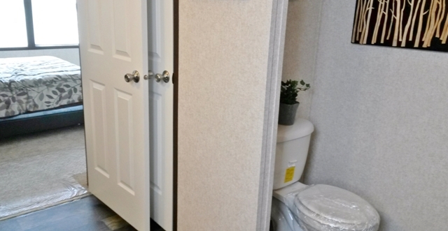 Commode is tucked away in the bath
