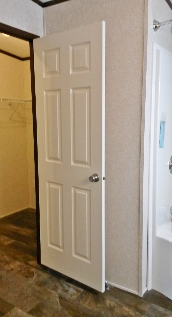 Master closet runs the entire length of bathroom